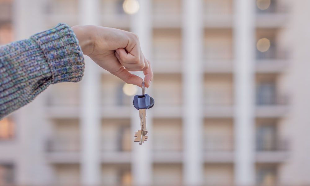 Mulher segura a chave depois de vender apartamento no Itaim Bibi